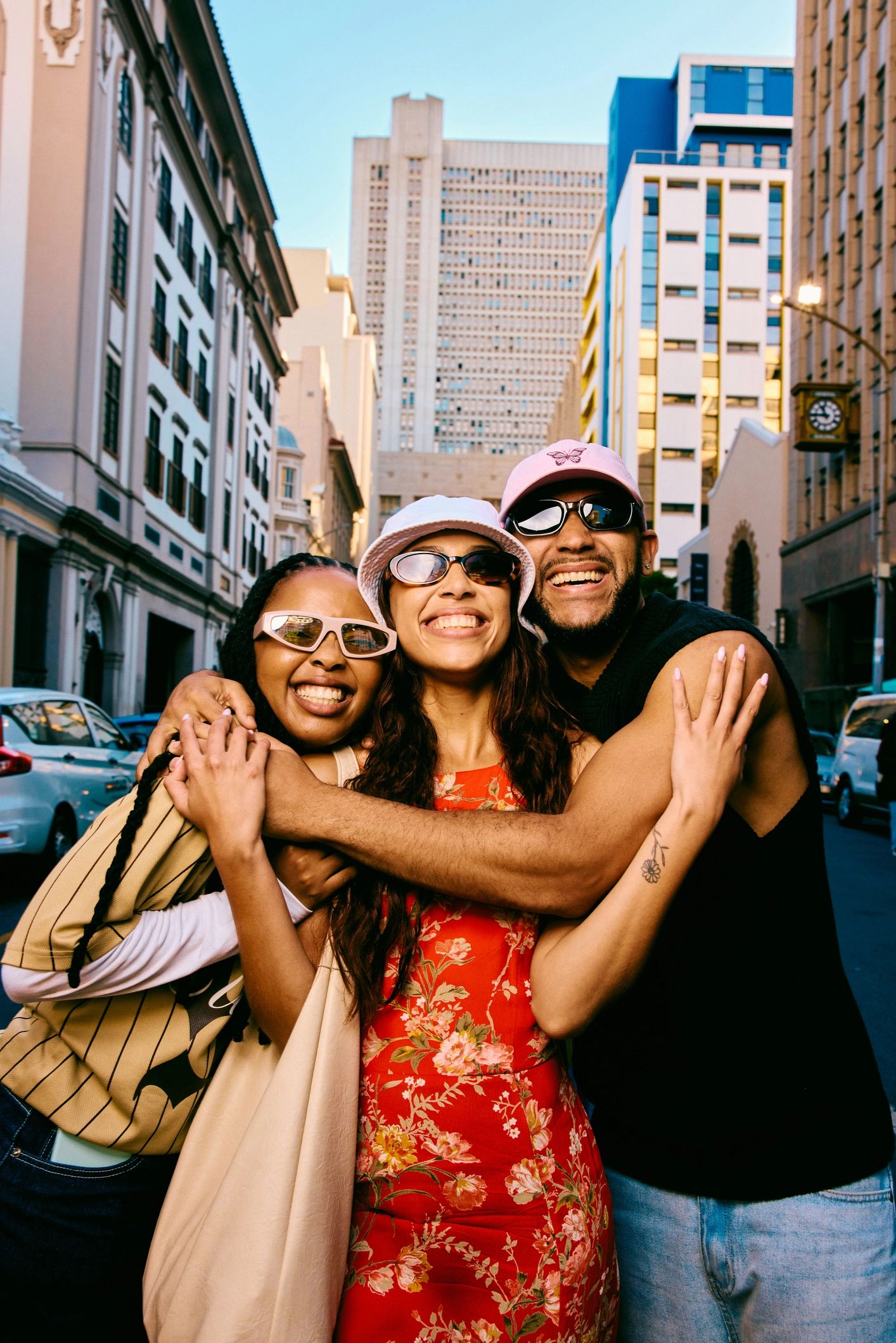 Friends embracing on a city street in expressive urban apparel